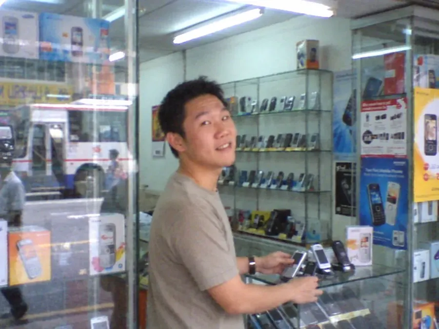 A young Aaron Chong behind a shop counter in his early selling days